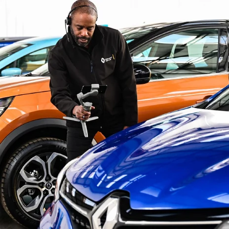Automotive presenter recording a vehicle in a showroom