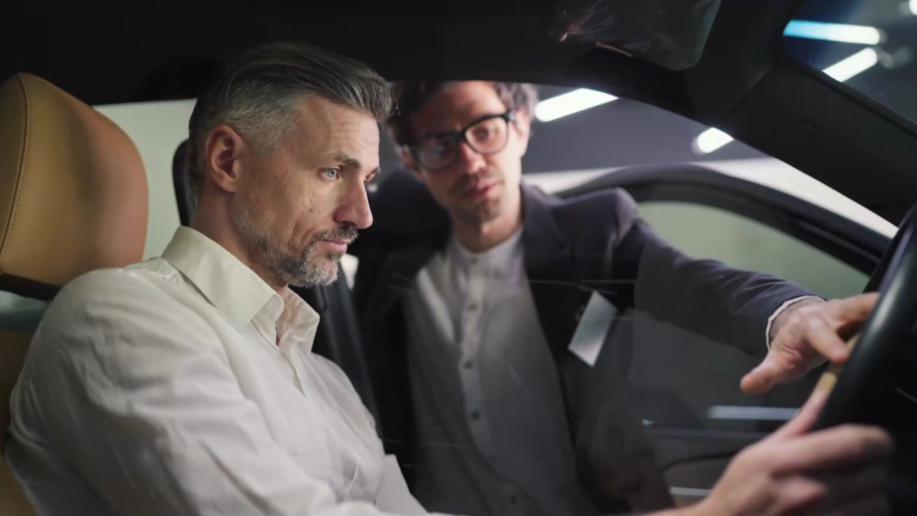 A prospective customer exploring a car in a showroom