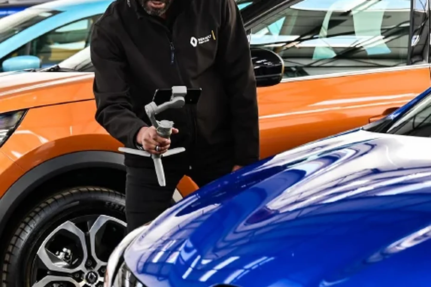 Automotive specialist using digital equipment around a vehicle