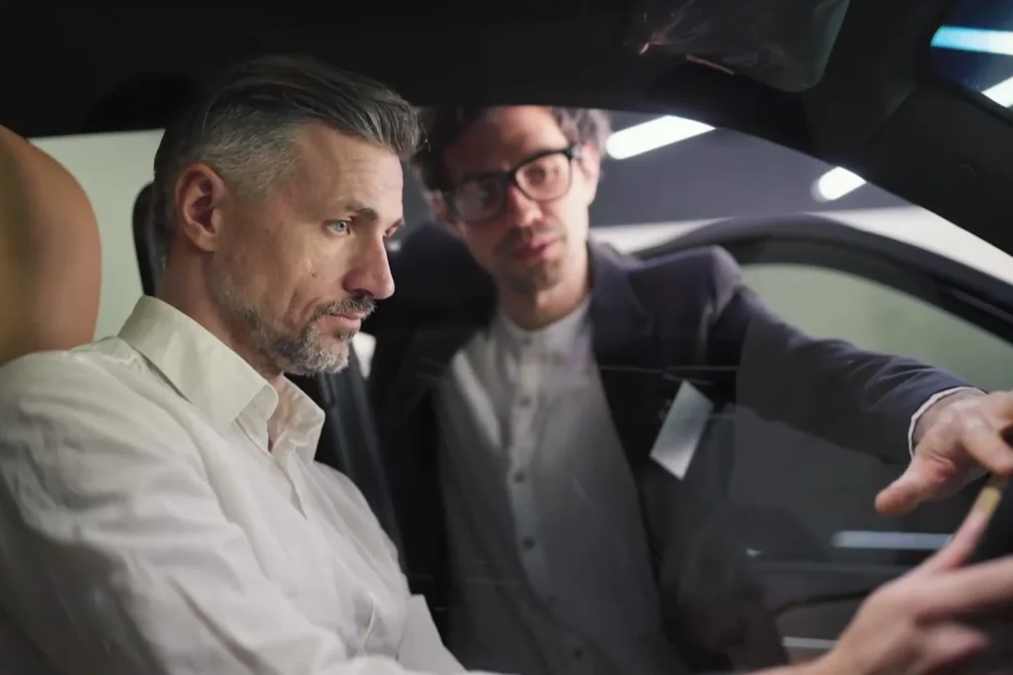 Automotive customer and specialist discussing a vehicle in a dealership